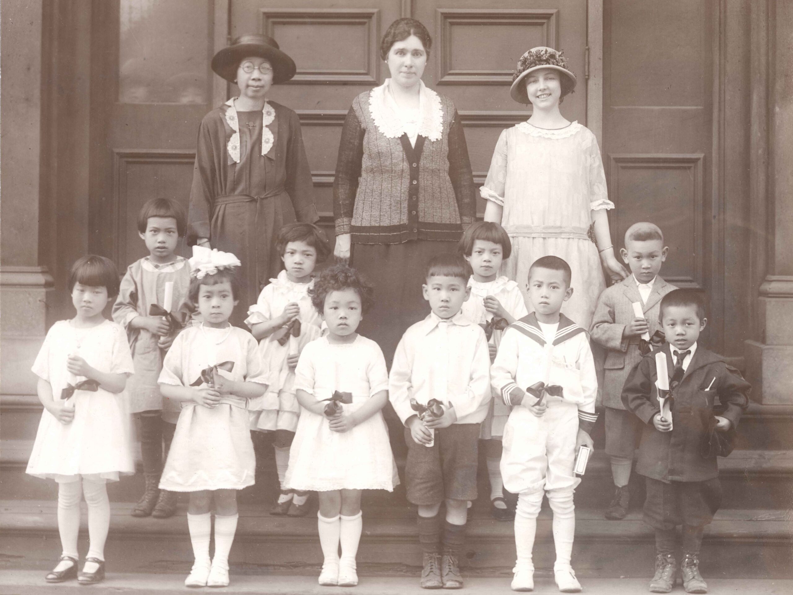 Kindergarten graduates of the Chinese Mission, [1924?]. Teachers and staff include Phoebe Chan (left) and Lily McCargar (right).<br><br><i>Chinese United Church (Vancouver, B.C.) fonds, item BCCA 2810.3</i>